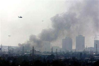Helicopters over burning city one week later.