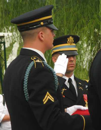 Pall bearers fold the flag that has draped the officer's coffin.