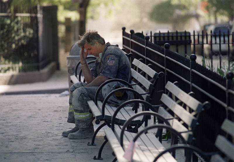 911, New York City: NY Fire Department fire fighter sits head in hand on bench