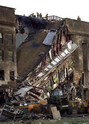 Photo: Steve Helber - AP. 911 - Firefighters on the roof of a sliced-through Pentagon.