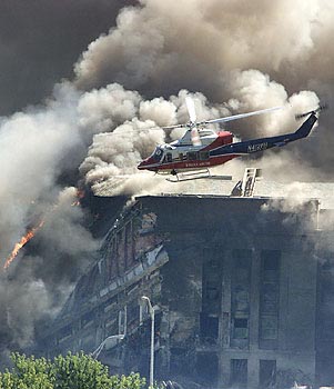 911 - smoke billows from Pentagon after being struck by flight AA77.