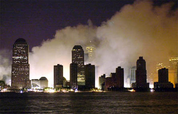 911 Glare and smoke lights the New York City skyline on the first night after the attacks.