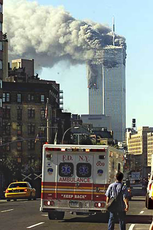 NYFD Ambulence races south to scene of smoking towers.