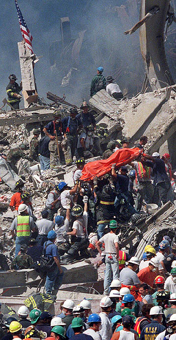 911 WTC - The Pile at Ground Zero - another red body bag come out of wreckage.