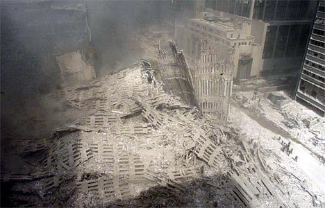 911 - The Towers' outer columns lie in rubble at Ground Zero.