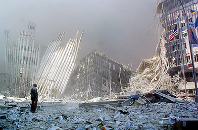911. Dusted in white silicates and pulverized concrete everywhere, the Towers' outer steel columns lie in piles of rubble.