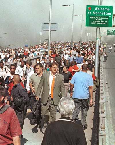 9/11 People flee the financial district and Lower Manhattan across the Brooklyn Bridge.