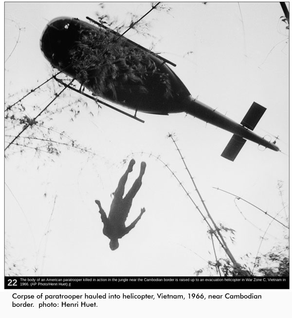 Paratrooper's corpse hauled skyward. Photo Henri Huet, 1966.